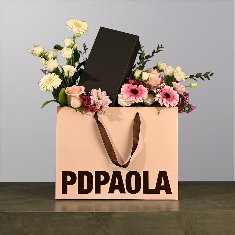 A box of flowers with jewelry box in it.