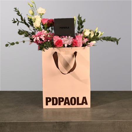 A box of flowers with jewelry box in it.