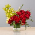A luxurious floral arrangement featuring premium blooms, delicate seasonal flowers, and fresh greenery, elegantly arranged in a decorative vase.