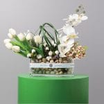 Glass vase with white tulip and orchid flowers for Saudi National Day