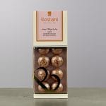 A pink chocolate box containing balls of chocolate.