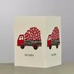 A card holder with the image of a red truck carrying red hearts.