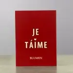 A red card holder with "Love You" written in French.