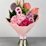 The Rosé Aura luxury bouquet featuring pink hydrangea, fuchsia spray roses, pink gerberas, anthuriums, purple allium, chrysanthemums and lily buds, wrapped in blush pink with Blumen’s signature ribbon.