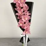 Zey Bloom luxury pink Cymbidium orchid bouquet wrapped in elegant black paper and finished with Blumen’s signature ribbon.