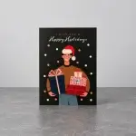 A black card holder with the image of a man holding giftboxes while wearing a Christmas hat.