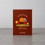 A card holder with an old couple standing on grass.