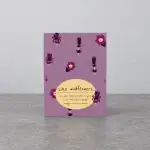 A purple card holder with wildflowers and a message written in a beige ellipse.