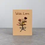 A beige card holder with the image of flowers stems wrapped together.
